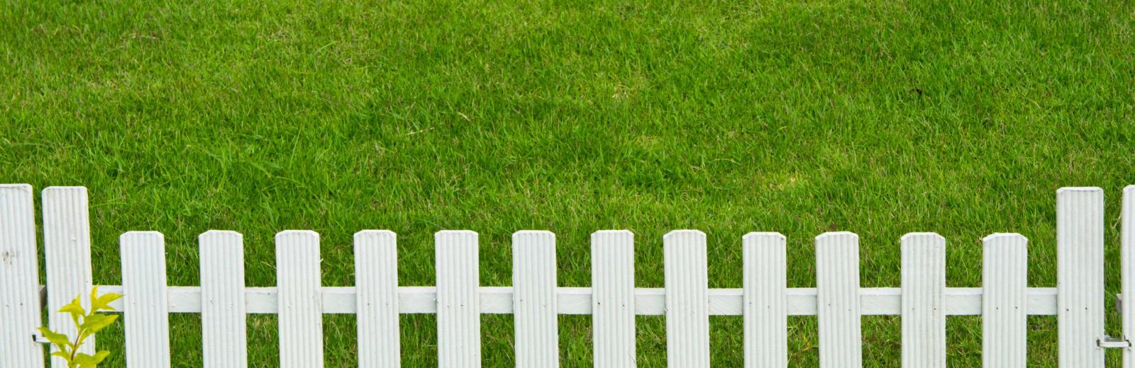 white fence on a lawn